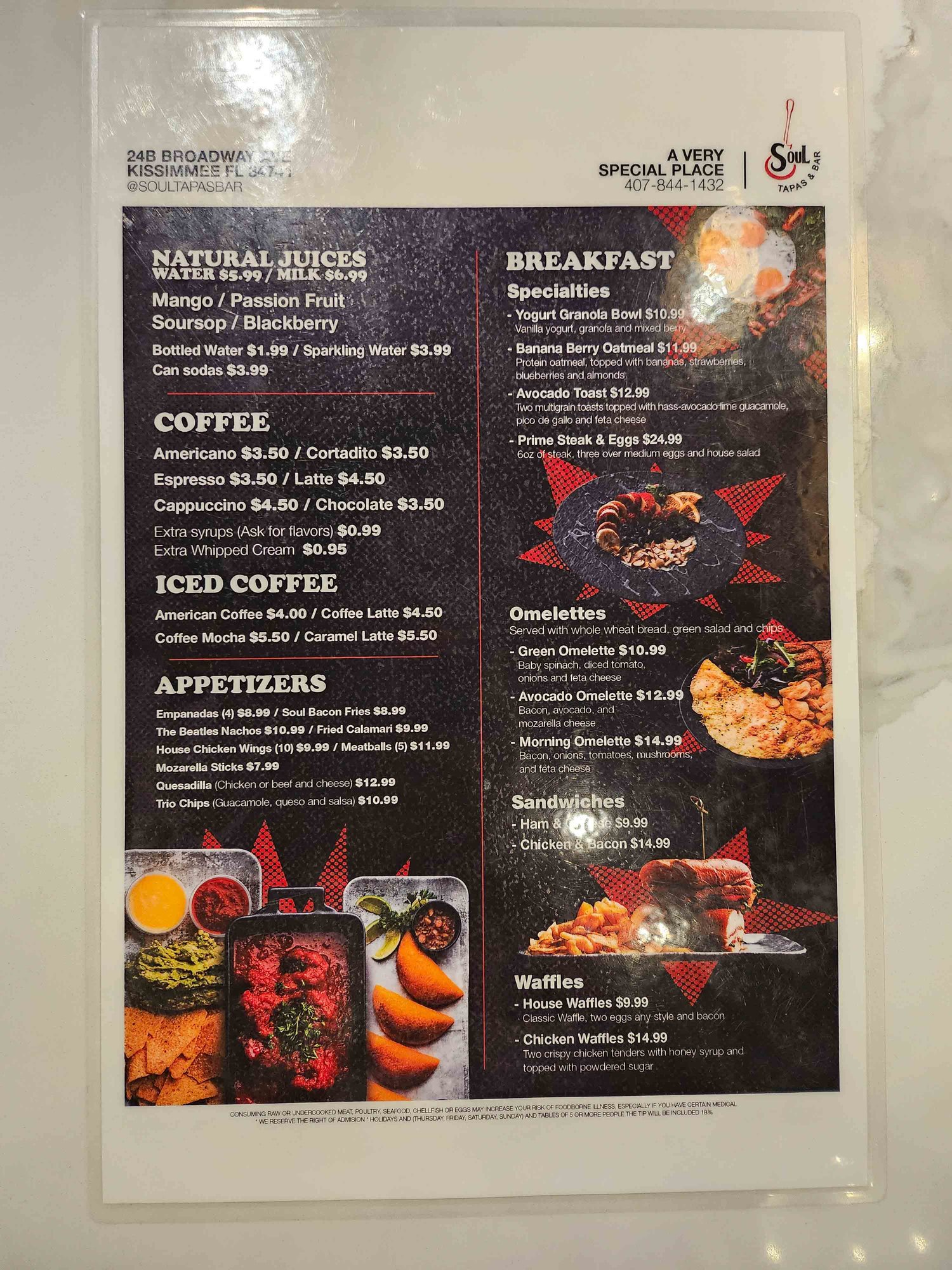 black laminated menu with food and drink items